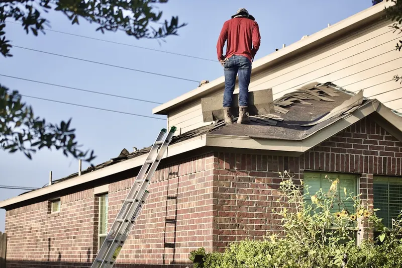 Professional roofer working on a residential roof in Baldy Mesa